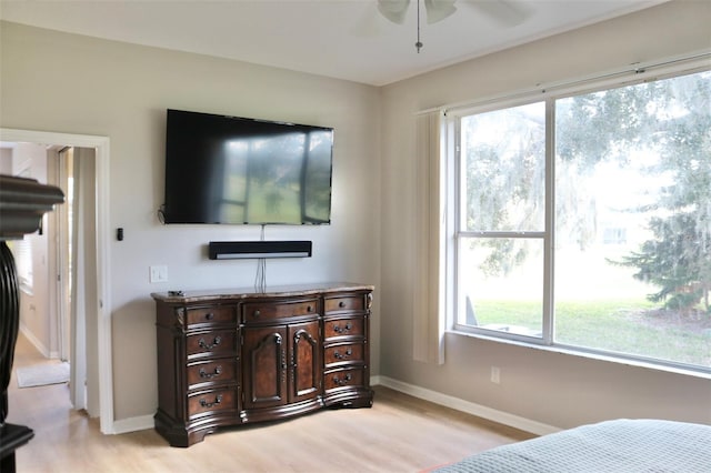 bedroom featuring light wood-style flooring and baseboards