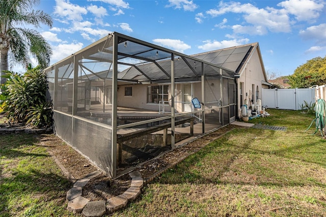 exterior space featuring a lanai and a lawn