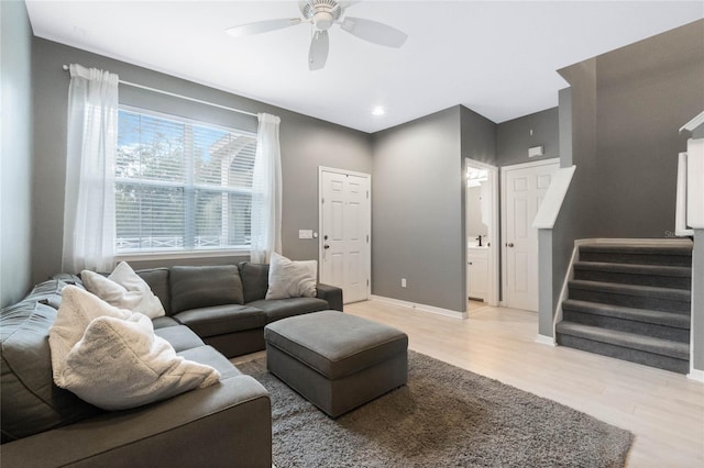 living room with light hardwood / wood-style flooring and ceiling fan