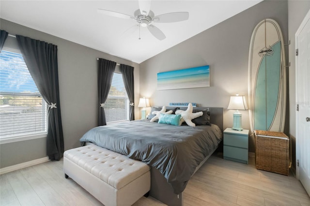 bedroom featuring ceiling fan, vaulted ceiling, and light wood-type flooring