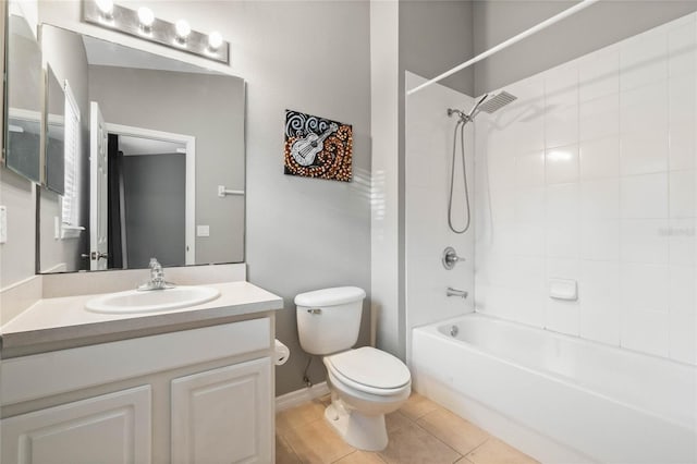 full bathroom featuring vanity, tiled shower / bath, tile patterned floors, and toilet