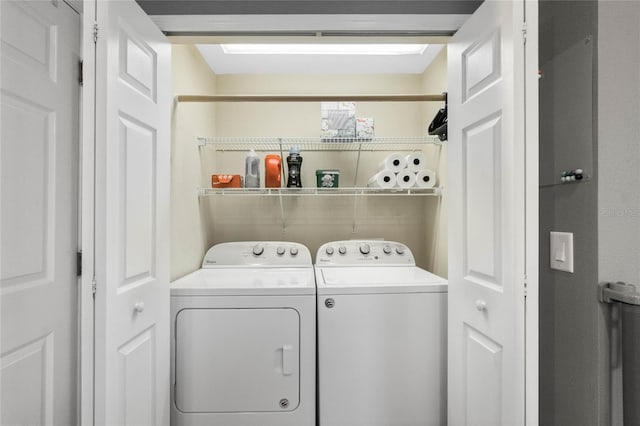 clothes washing area with washer and clothes dryer