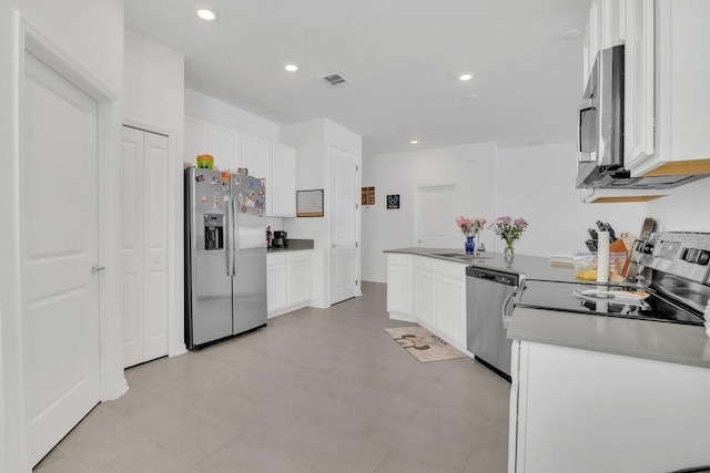 kitchen featuring stainless steel appliances, white cabinetry, and sink