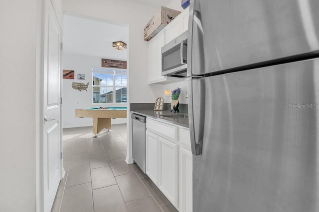 kitchen with white cabinetry, billiards, appliances with stainless steel finishes, and light tile patterned floors