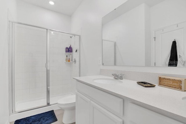 bathroom featuring vanity, toilet, and walk in shower