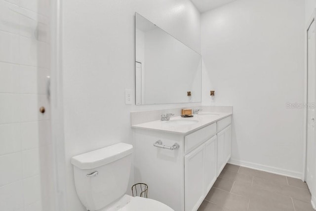 bathroom with vanity, tile patterned flooring, and toilet