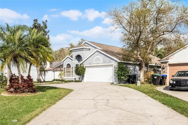 view of front of home featuring a garage and a front lawn