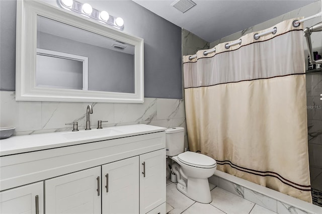 bathroom with vanity, toilet, tile walls, and walk in shower