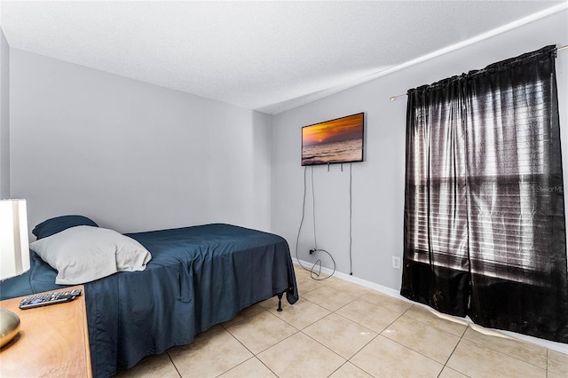 tiled bedroom featuring a textured ceiling