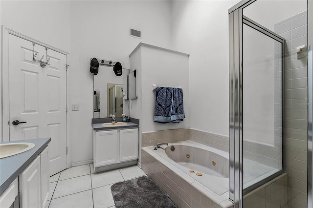 bathroom with vanity, independent shower and bath, and tile patterned flooring