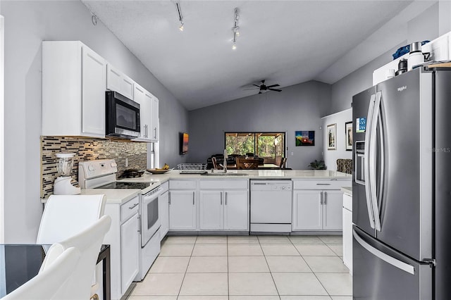 kitchen featuring ceiling fan, appliances with stainless steel finishes, white cabinets, light tile patterned flooring, and kitchen peninsula