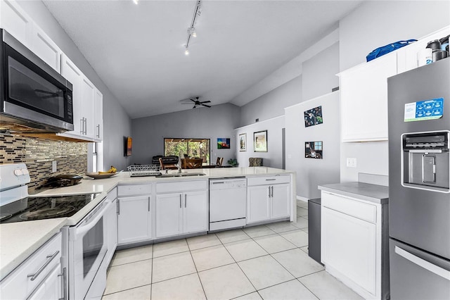 kitchen featuring stainless steel appliances, kitchen peninsula, white cabinets, and light tile patterned flooring