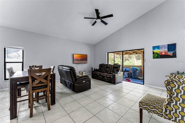 tiled living room featuring ceiling fan and high vaulted ceiling