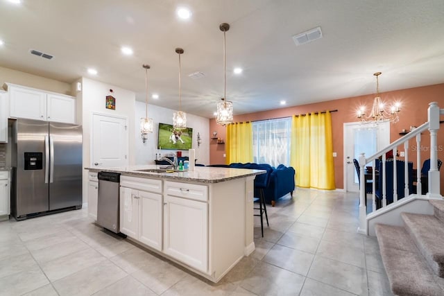 kitchen featuring white cabinetry, an island with sink, and appliances with stainless steel finishes