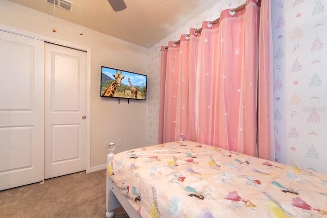 bedroom with carpet flooring, ceiling fan, and a closet