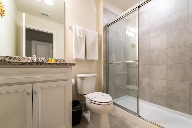 bathroom with vanity, toilet, and an enclosed shower