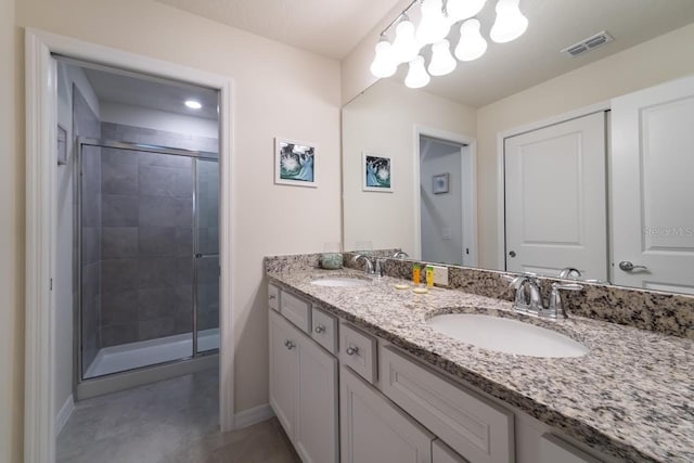 bathroom with vanity and a shower with door