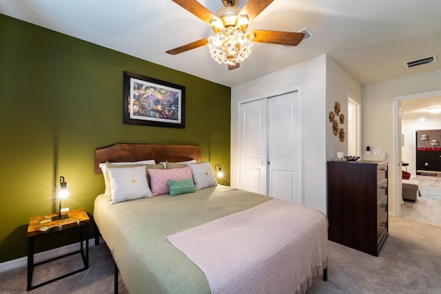 carpeted bedroom featuring ceiling fan and a closet