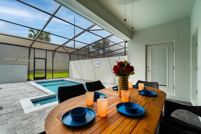 view of swimming pool featuring a patio and glass enclosure