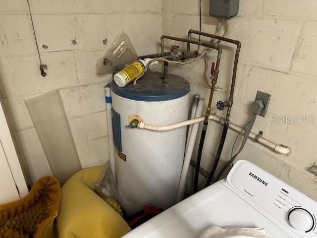 utility room with electric water heater