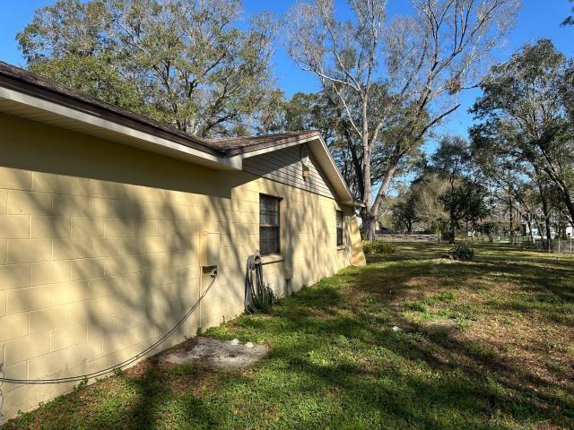 view of property exterior with a yard