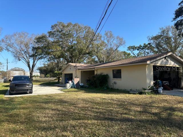 view of home's exterior with a yard and a garage