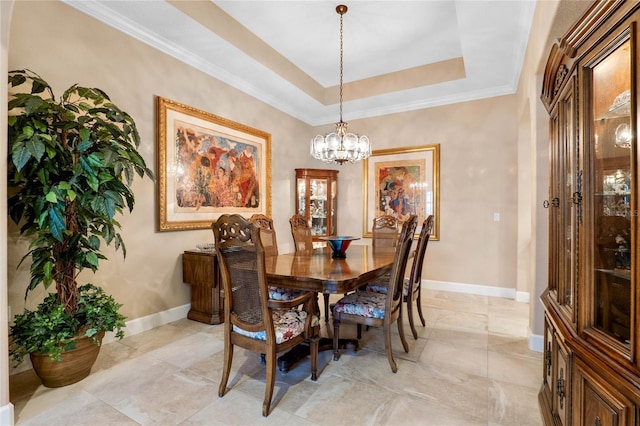 dining space featuring an inviting chandelier, crown molding, and a raised ceiling