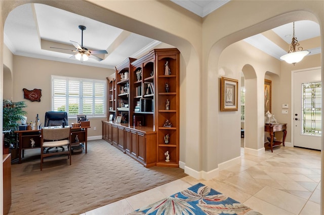 office space with crown molding, light tile patterned floors, ceiling fan, and a tray ceiling