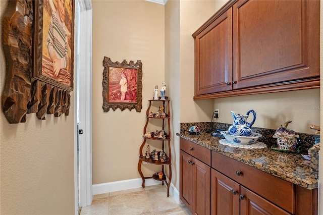 interior space featuring dark stone countertops and light tile patterned floors