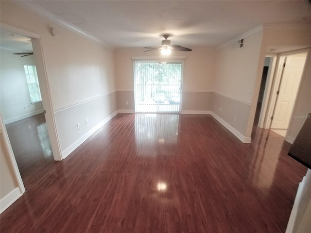 spare room with dark hardwood / wood-style flooring, ornamental molding, and ceiling fan