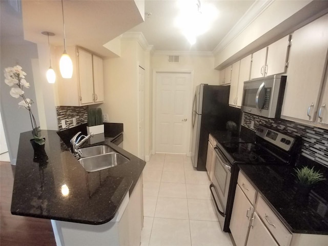 kitchen with white cabinetry, stainless steel appliances, sink, and hanging light fixtures