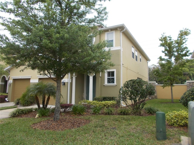 view of front of home with a garage and a front lawn