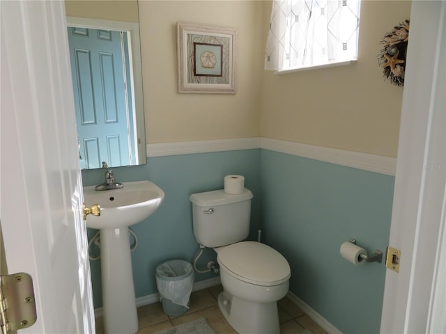 bathroom with sink, toilet, and tile patterned flooring