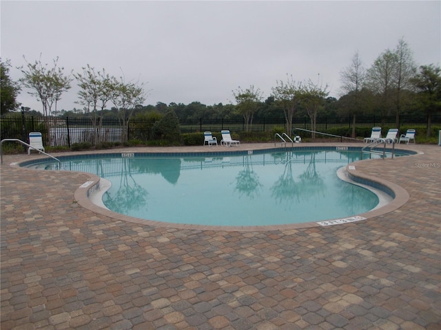 view of swimming pool featuring a patio area