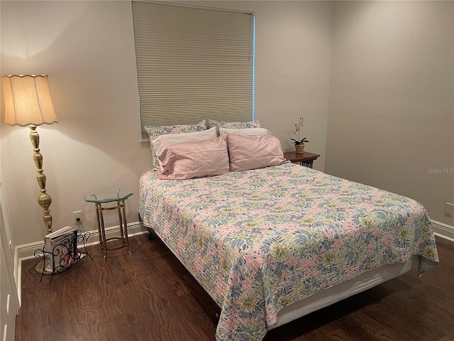 bedroom featuring dark wood-style floors and baseboards