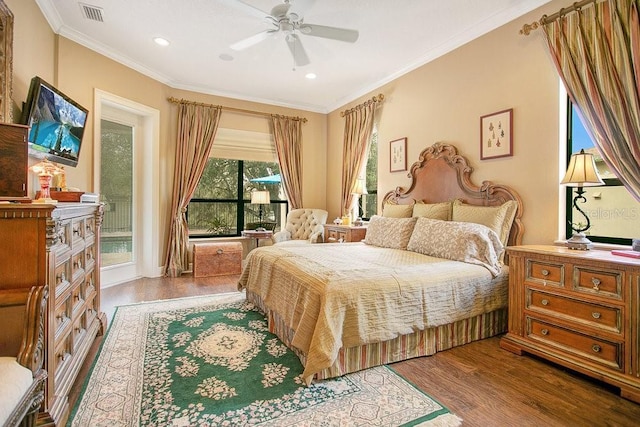 bedroom featuring access to exterior, crown molding, visible vents, and wood finished floors