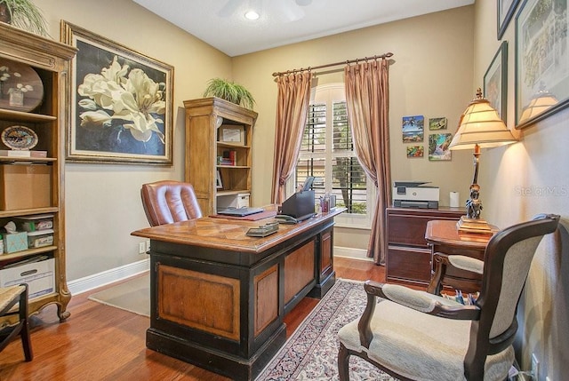 office with baseboards and wood finished floors