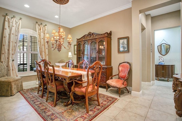 dining space featuring baseboards, ornamental molding, and a notable chandelier