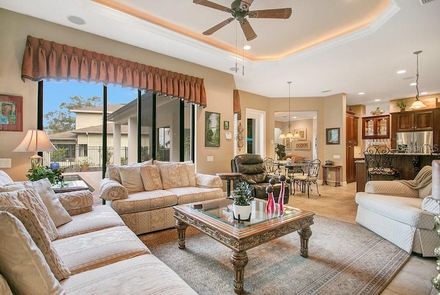 living area with light tile patterned floors, visible vents, a raised ceiling, ceiling fan with notable chandelier, and recessed lighting