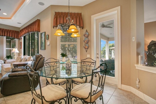 dining space featuring light tile patterned floors, baseboards, and ornamental molding