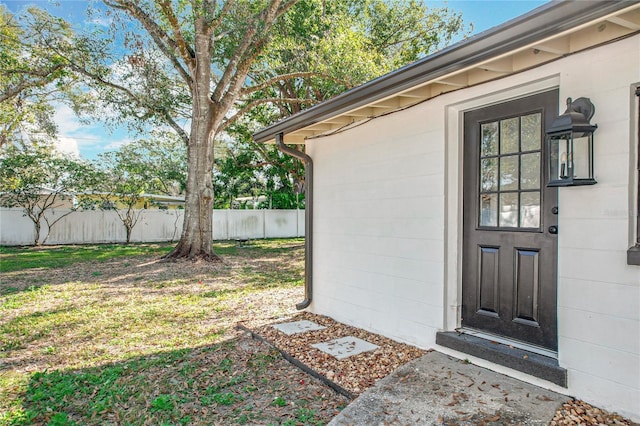 property entrance with a yard