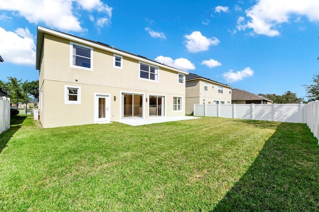 back of property featuring a patio area and a lawn