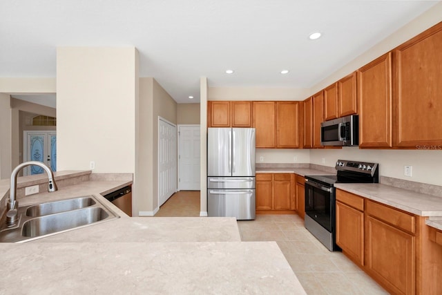 kitchen featuring appliances with stainless steel finishes, sink, and light tile patterned floors