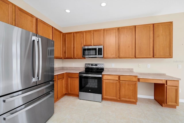 kitchen with light tile patterned floors and stainless steel appliances