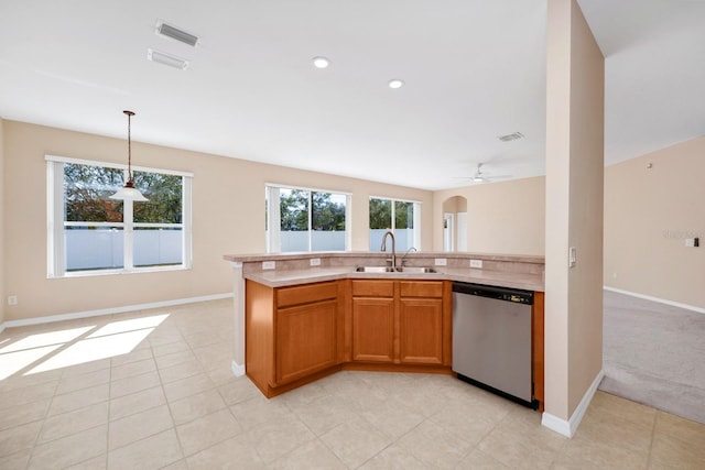 kitchen featuring sink, hanging light fixtures, light tile patterned floors, a center island with sink, and stainless steel dishwasher