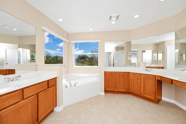 bathroom featuring shower with separate bathtub, vanity, and tile patterned floors