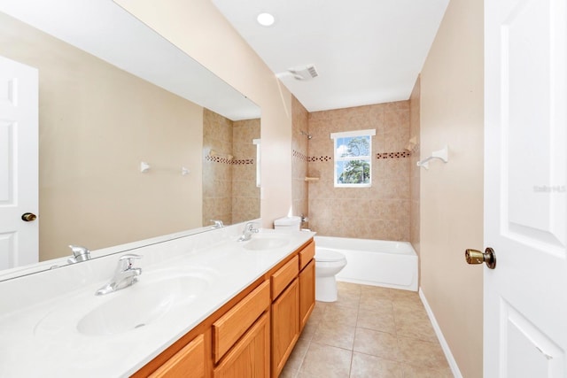 full bathroom with vanity, tiled shower / bath, tile patterned floors, and toilet