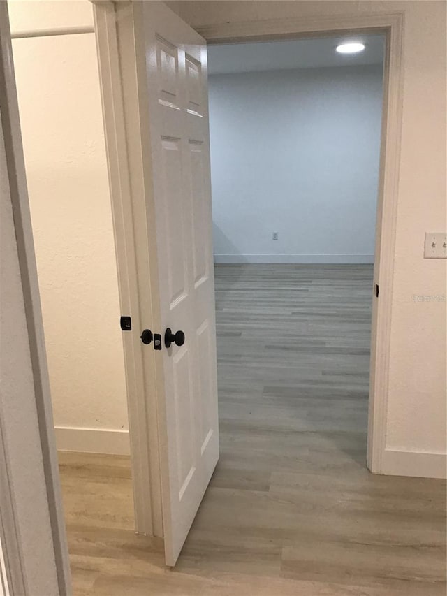 hallway with light hardwood / wood-style flooring