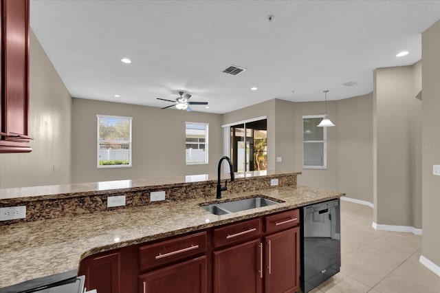 kitchen with sink, hanging light fixtures, light tile patterned floors, black dishwasher, and light stone countertops