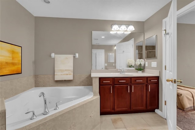 bathroom featuring tile patterned flooring, vanity, and a relaxing tiled tub